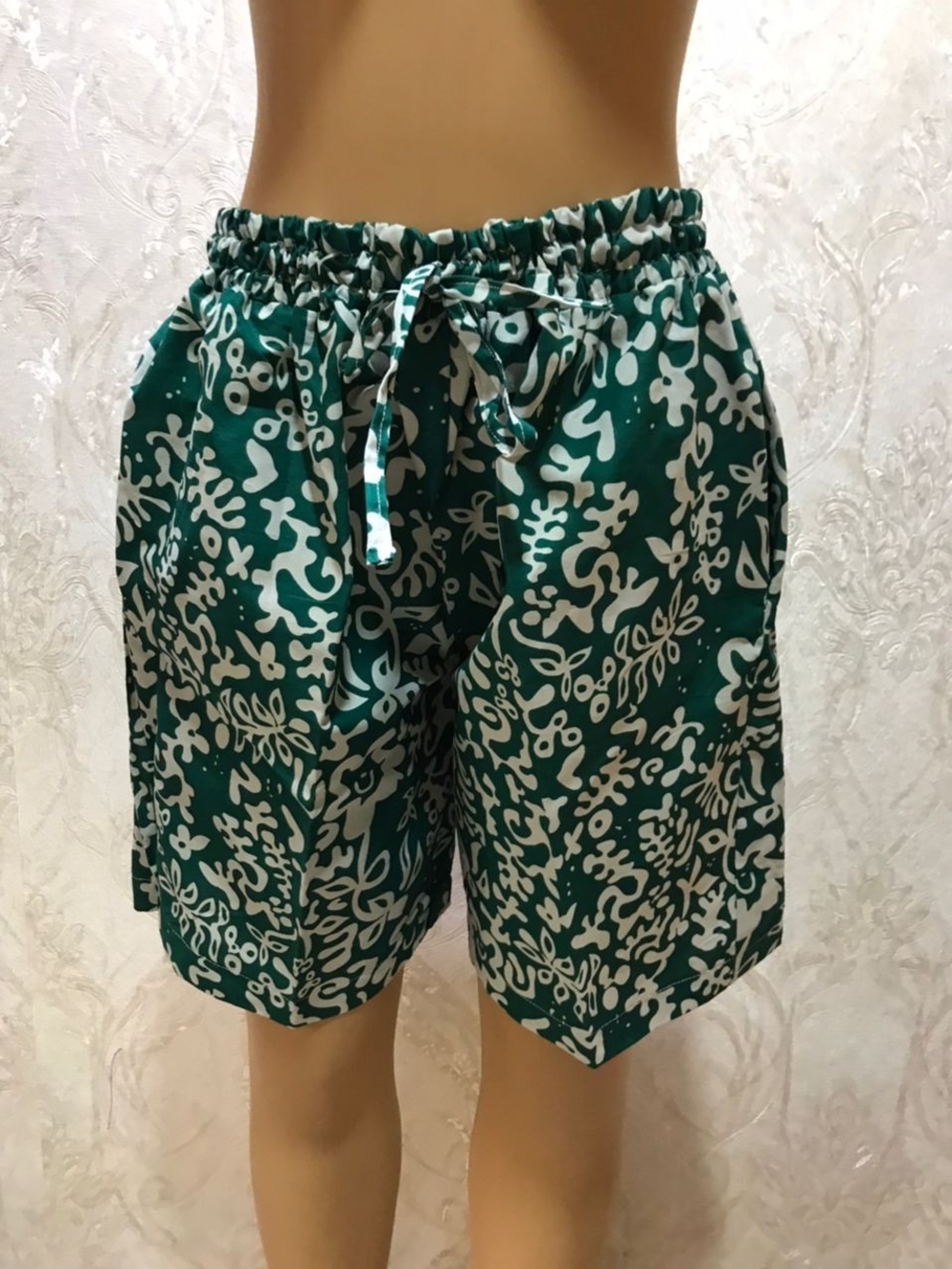 Green and White Patterned Drawstring Shorts and White Tshirt